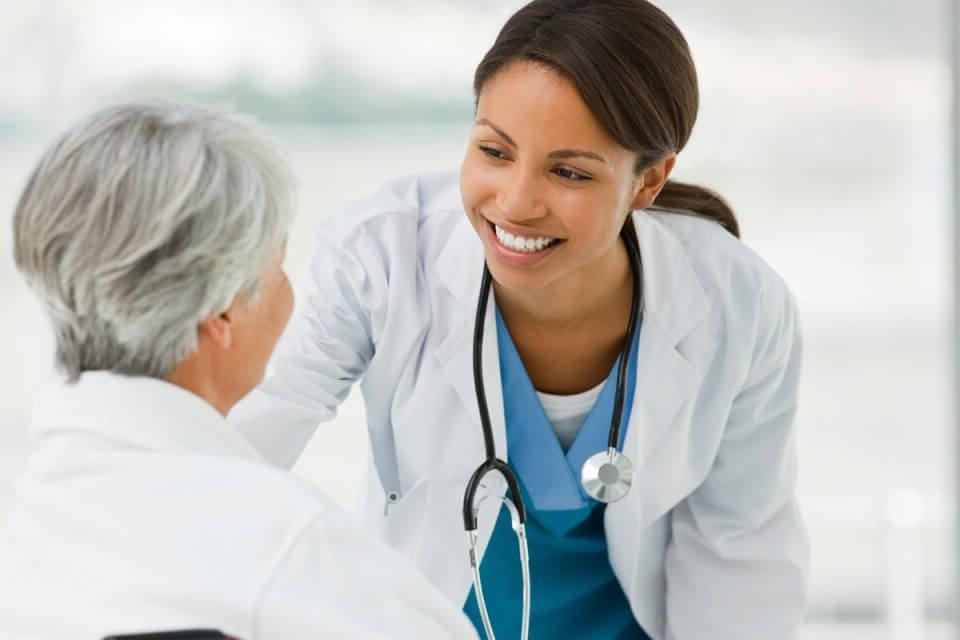 AGNP Nurse Practitioner Smiling with Adult Female Patient