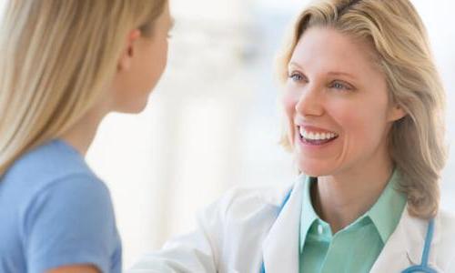 Family Nurse Practitioner with Post Master's Certificate Smiling at Young Patient 